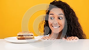 Hungry Lady Looking At Burger Peeping Out Table