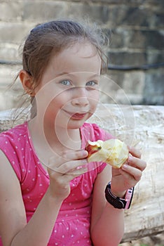 Hungry Little Girl Portrait Eating Red Apple Outdoor Healthy Snack for Kids Bite the Fruit Apple. girl in Pink Dress.