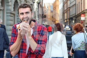 Hungry male devouring a hot dog