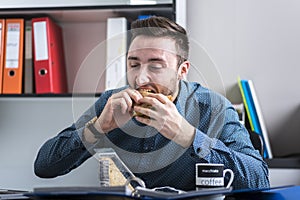 Hungry man eating a sandwich