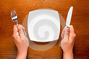 Hungry man with empty plate