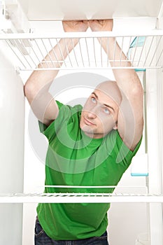 Hungry man in fridge