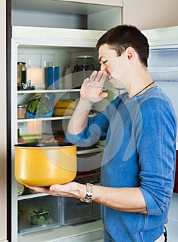 Hungry man holding foul food