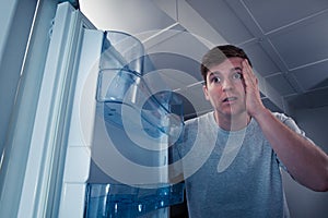 Hungry man looking in refrigerator