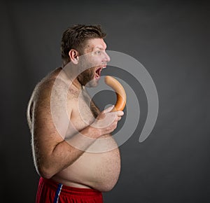 Hungry man with a sausage