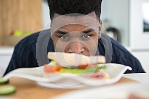 hungry man staring at sandwich