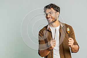 Hungry man waiting for serving dinner meal dishes with restlessness holding cutlery fork knife