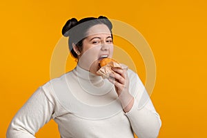 Hungry Plus Size Girl With Overweight Eating Tasty Burger And Looking At Camera