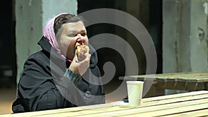 Hungry poor woman having meal at charity shelter, social aid, poverty problem