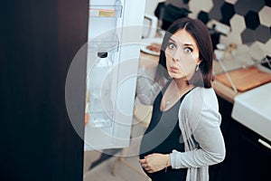 Hungry Pregnant Woman Checking the Fridge for Food