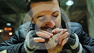 Hungry and tired factory worker eating vegetarian sandwich. Healthy food