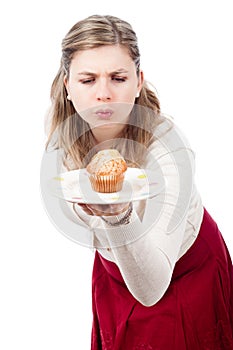 Hungry woman with delicious sweet muffin