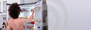 Hungry Woman Eating From Fridge