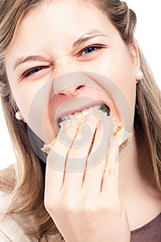 Hungry woman eating sandwich
