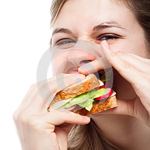 Hungry woman eating sandwich