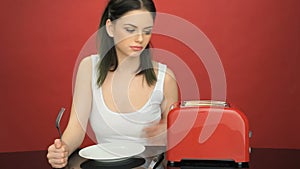 Hungry woman with an empty dinner plate