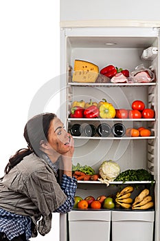 Hungry woman and a fridge full of food