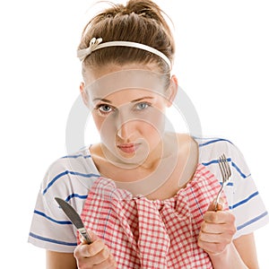 Hungry woman with knife and fork