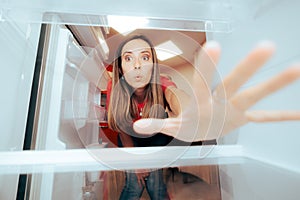 Hungry Woman Reaching for Something to Eat in the Fridge