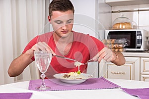 Hungry Young Man Eating Home Cooked Spaghetti Meal