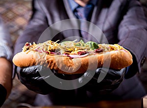 Hungry young man eating a hot dogs in cafe. Restaurant