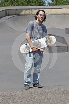 Hunk posing with his skateboard