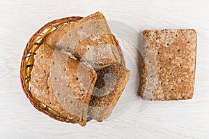 Hunks of rye bread in wicker basket and on table