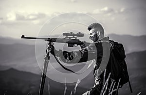 Hunter is aiming. The man is on the hunt. Hunt hunting rifle. Hunter man. Shooter sighting in the target. Hunting period
