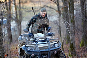 Hunter on ATV in the forest