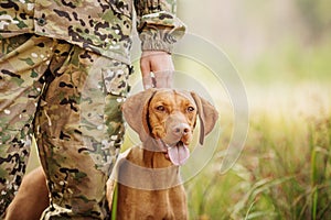 Hunter with a dog on the forest