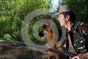 Hunter with dog in rifle. Ambush