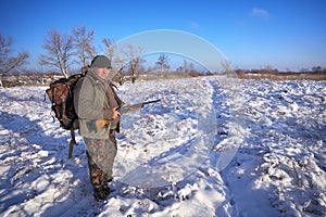 Hunter on field waiting victim. Winter hunting.