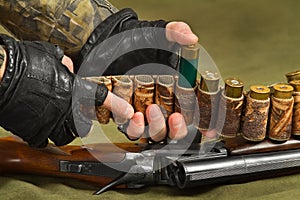 Hunter fills a bandoleer of ammunition for the shotgun