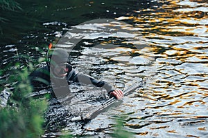 Hunter Fisherman is Hunting a Fish on the River