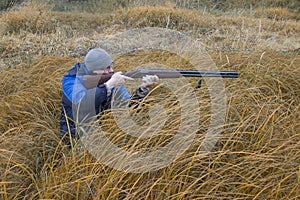 Hunter with a gun . Autumn duck hunting