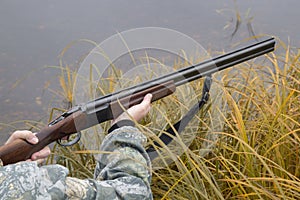 Hunter with a gun . Autumn duck hunting