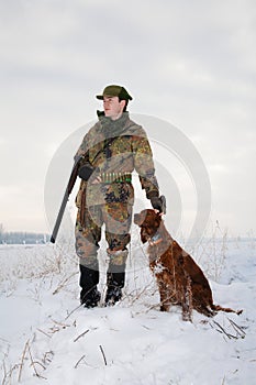 Hunter and his hunting dog in winter open season