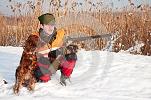 Hunter and his hunting dog in winter open season