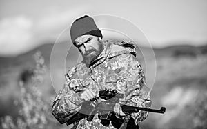 Hunter hold rifle. Focus and concentration of experienced hunter. Hunting and trapping seasons. Hunting masculine hobby