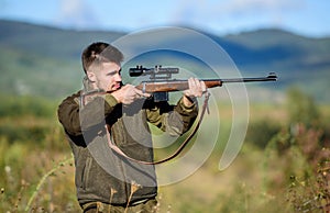 Hunter hold rifle. Focus and concentration of experienced hunter. Hunting and trapping seasons. Hunting permit. Man