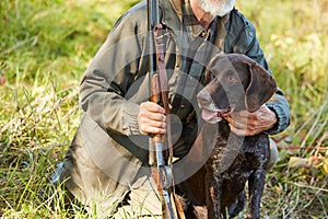 Hunter hugging his dog in forest