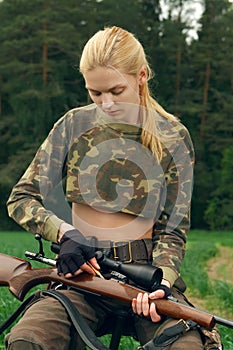 Hunter loading bullet to carbine with optical-sight.