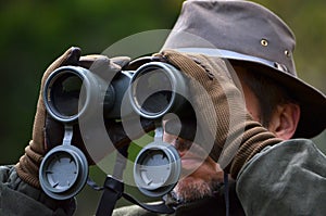 Hunter looking through binoculars
