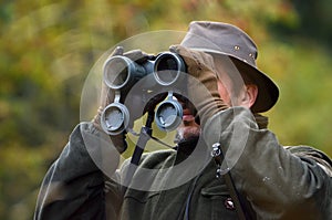 Hunter looking through binoculars