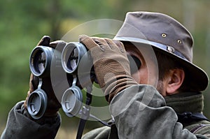 Hunter looking through binoculars