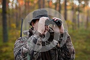 Hunter looking into binoculars