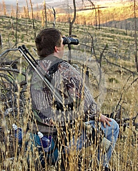 Hunter looking for deer with binoculars