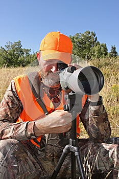 Hunter looking through spotting scope close-up