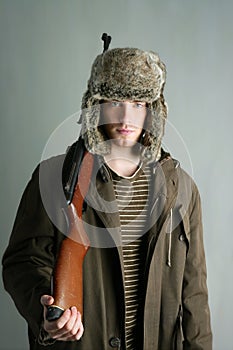 Hunter man fur winter hat holding rifle gun