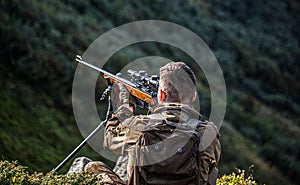 Hunter man. Hunting period. Male with a gun. Close up. Hunter with hunting gun and hunting form to hunt. Hunter is